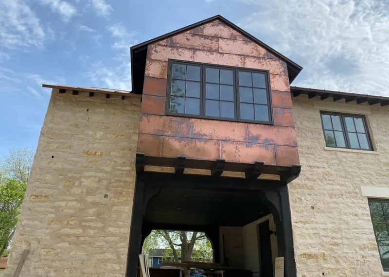 Copper metal panel facade on a stone building for Metal Roof Coating in Salida del Sol Estates