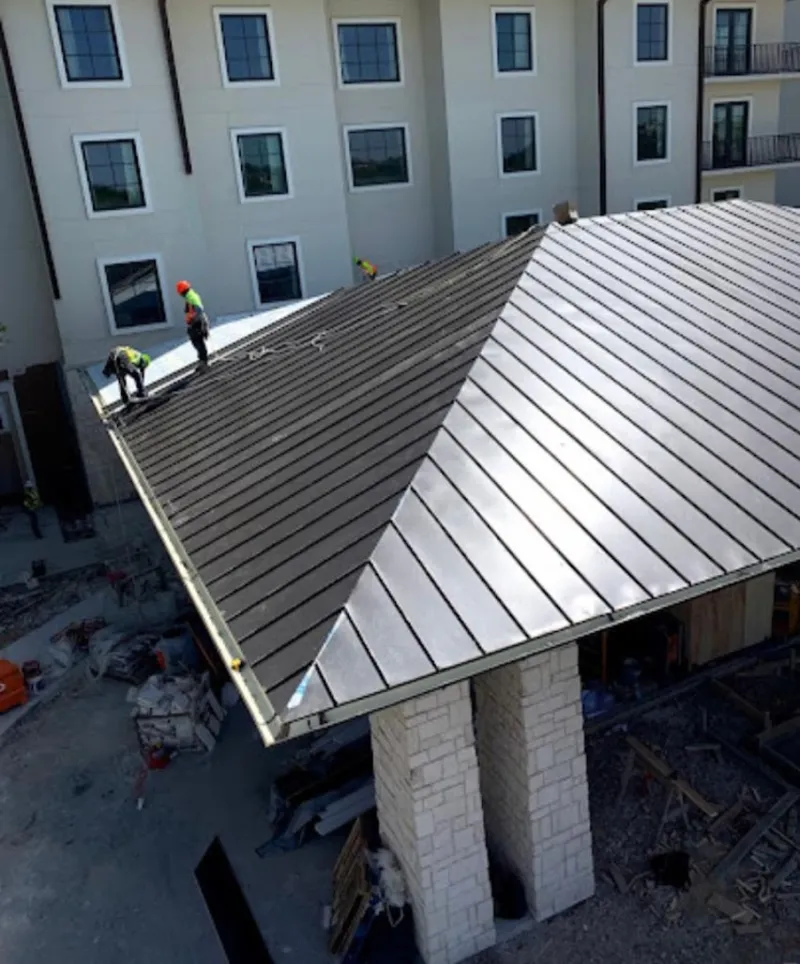 Crew installing standing seam metal roof panels on a commercial project in Salida del Sol Estates